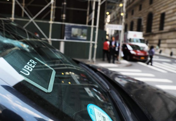 (FILES) This file photo taken on June 14, 2017 shows an Uber SUV waiting for a client in Manhattan in New York City. Uber said June 21, 2017 that its embattled chief executive Travis Kalanick had agreed to step down from his job, as the company tries to clean up a corporate culture that has sparked charges of harassment and discrimination. Kalanick had already been on a leave of absence aimed at restoring confidence in the scandal-plagued ridesharing giant. / AFP PHOTO / GETTY IMAGES NORTH AMERICA / SPENCER PLATT