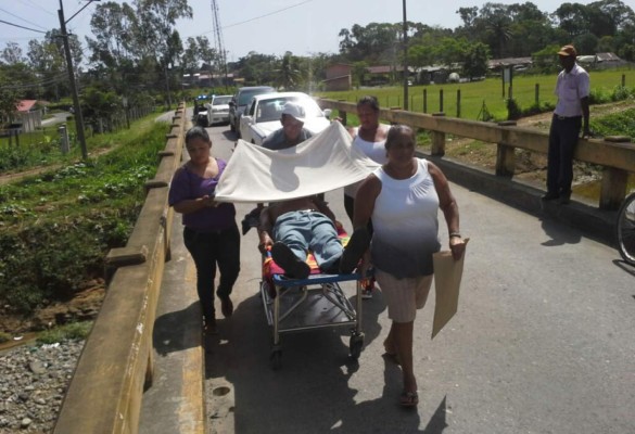 Familiares de Santos Fito Burgos Amador (60) los trasladan en una camilla a un centro médico privado.
