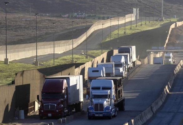 Trucks drive to cross the border with the United States at Otay Mesa Commercial Port of Entry in Tijuana, Mexico on January 22, 2018. Negotiators from Canada, Mexico and the United States on Tuesday will kick off the sixth round of talks aimed at revamping the North American Free Trade Agreement (NAFTA) in Montreal. / AFP PHOTO / GUILLERMO ARIAS