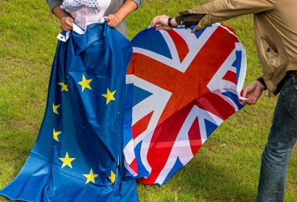 Two people hold an European Union and United Kingdom at the castle of Hardelot, the cultural center of the Entente Cordiale (the colonial-era promise of cross-channel friendship between Britain and France). Britain has voted to break out of the European Union, striking a thunderous blow against the bloc and spreading panic through world markets on June 24, 2016 as sterling collapsed to a 31-year low. / AFP PHOTO / PHILIPPE HUGUEN