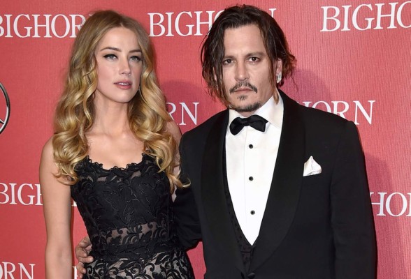 FILE - In this Jan. 2, 2016 file photo, Amber Heard, left, and Johnny Depp arrive at the 27th annual Palm Springs International Film Festival Awards Gala in Palm Springs, Calif. Court records show Heard filed for divorce in Los Angeles Superior Court on Monday, May 23, 2016, citing irreconcilable differences. The pair were married in February 2015 and have no children together. (Photo by Jordan Strauss/Invision/AP, File)