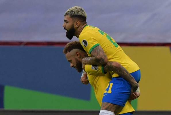 Brazil's Gabriel Barbosa (R) celebrates with teammate Neymar after scoring against Venezuela during the Conmebol Copa America 2021 football tournament group phase match at the Mane Garrincha Stadium in Brasilia on June 13, 2021. (Photo by NELSON ALMEIDA / AFP)