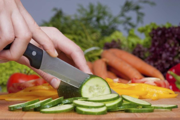 Cutting cucumber and vegetagles on backgound