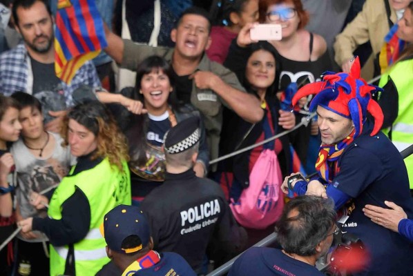 Barcelona's Spanish midfielder Andres Iniesta looks at Barcelona fans as the team parades aboard an open-top bus to celebrate their 25th La Liga title in Barcelona on April 30, 2018.Barcelona won their 25th La Liga title after a 4-2 win against Deportivo La Coruna. / AFP PHOTO / LLUIS GENE
