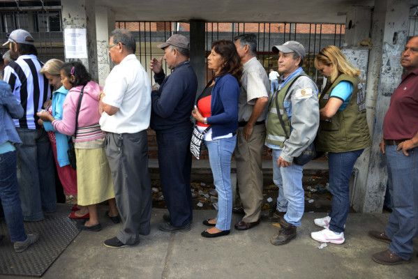 Venezolanos compran con número en la muñeca