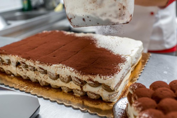 Making tiramisu cookies with savoiardi and mascarpone in the restaurant kitchen