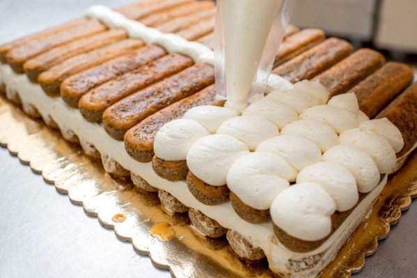 Making tiramisu cookies with savoiardi and mascarpone in the restaurant kitchen