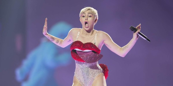In this picture made available on Tuesday, May 27, 2014 US singer Miley Cyrus performs during a concert in Cologne, Germany, Monday, May 26, 2014. (AP Photo/dpa,Marius Becker)
