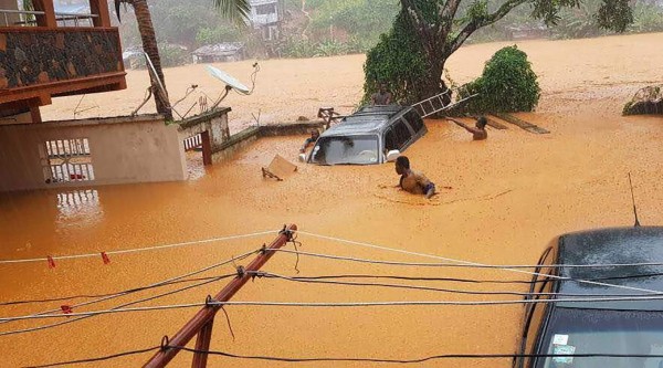 This picture shows flooded streets in Regent near Freetown, on August 14, 2017.The death toll from massive flooding in the Sierra Leone capital of Freetown climbed to 312 on August 14, 2017, the local Red Cross told AFP. Red Cross spokesman Patrick Massaquoi told AFP the toll could rise further as his team continued to survey disaster areas in Freetown, where heavy rains have caused homes to disappear under water and triggered a mudslide. / AFP PHOTO / Society 4 climate change communication Sierra Leone / STR / RESTRICTED TO EDITORIAL USE - MANDATORY CREDIT 'AFP PHOTO / 'S4CCC-SL' - NO MARKETING NO ADVERTISING CAMPAIGNS - DISTRIBUTED AS A SERVICE TO CLIENTS