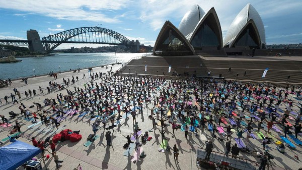 Sydneysiders enagage in a yoga event in front of the Australia's iconic landmark Opera House in Sydney on June 21, 2016. Hundreds of Yoga lovers gathered at Opera House to mark the International Yoga Day. / AFP PHOTO / Wendell Teodoro