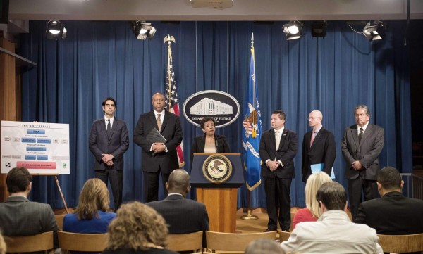 US Attorney General Loretta Lynch speaks at a press conference with, from L to R, Assistant US Attorney for the Eastern District of New York Evan Norris, US Attorney for the Eastern District of New York Robert Capers, FBI Assistant Director in charge of the New York Field Office Diego Rodriguez, IRS Criminal Investigation Chief Richard Weber and IRS Special Agent in charge of the Los Angeles Field Office Erick Martinez, about the corruption scandal engulfing FIFA at the Justice Department in Washington, DC, on December 3, 2015. The scandal widened with the arrests of two more top officials in another dramatic dawn raid at a luxury hotel in Zurich, as football's world body announced reforms aimed at repairing its tarnished reputation. AFP PHOTO/NICHOLAS KAMM