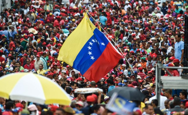 Supporters of Venezuelan president Nicolas Maduro attend a meeting in Caracas on October 28, 2016Maduro threatened on Friday to jail his political opponents if they follow through on their vow of launching a legislative trial to remove him from power. 'If they launch a supposed political trial, which is not in our constitution, the state prosecution service must bring legal action in the courts and put in jail anyone who violates the constitution, even if they are members of congress,' Maduro said in a public speech. / AFP PHOTO / JUAN BARRETO