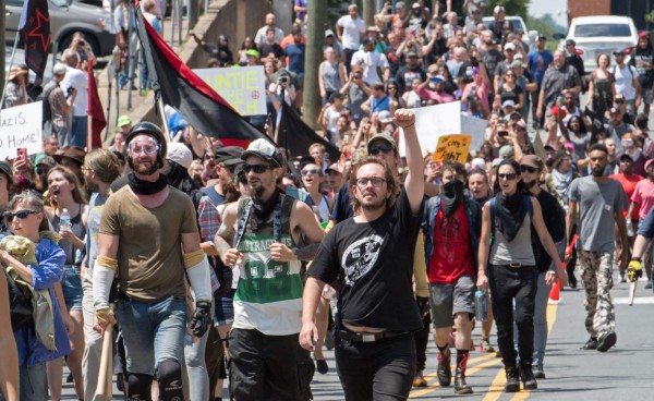 Protesters march in Charlottesville, Virginia on August 12, 2017. A picturesque Virginia city braced Saturday for a flood of white nationalist demonstrators as well as counter-protesters, declaring a local emergency as law enforcement attempted to quell early violent clashes. / AFP PHOTO / PAUL J. RICHARDS