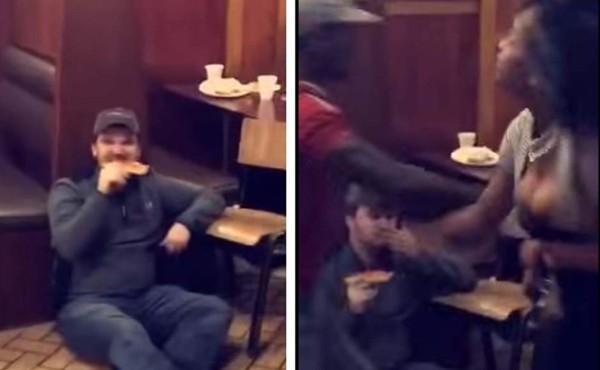 Hombre come pizza tranquilamente mientras hay una pelea frente a él