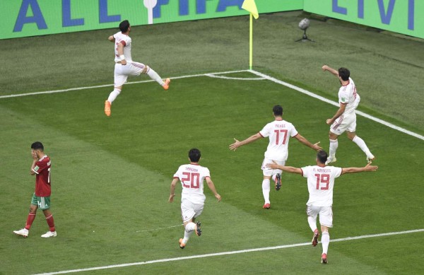 Iran's players celebrate after Morocco scored an own goal during the Russia 2018 World Cup Group B football match between Morocco and Iran at the Saint Petersburg Stadium in Saint Petersburg on June 15, 2018. / AFP PHOTO / GABRIEL BOUYS / RESTRICTED TO EDITORIAL USE - NO MOBILE PUSH ALERTS/DOWNLOADS