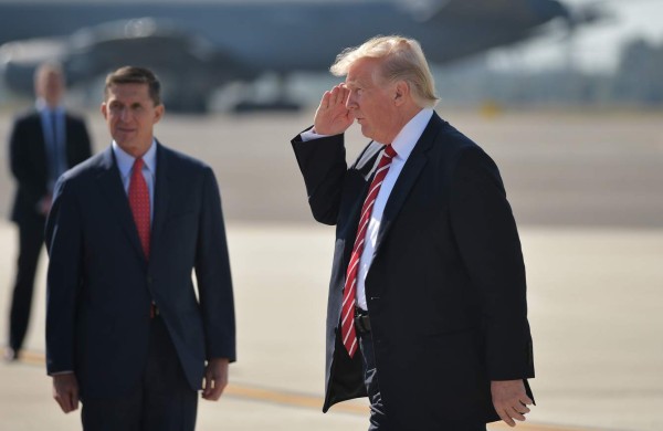 (FILES) This file photo taken on February 06, 2017 shows National Security Advisor Michael Flynn (L) and US President Donald Trump (R) upon arrival at MacDill Air Force Base in Tampa, Florida to visit the US Central Command and Specials Operations Command. The White House announced February 13, 2017 that Michael Flynn has resigned as President Donald Trump's national security advisor, amid escalating controversy over his contacts with Moscow. In his formal resignation letter, Flynn acknowledged that in the period leading up to Trump's inauguration: 'I inadvertently briefed the vice president-elect and others with incomplete information regarding my phone calls with the Russian ambassador.' / AFP PHOTO / MANDEL NGAN