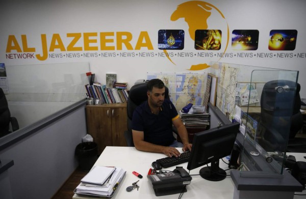 Employees of Qatar based news network and TV channel Al-Jazeera are seen at their Jerusalem office on July 31, 2017, / AFP PHOTO / AHMAD GHARABLI