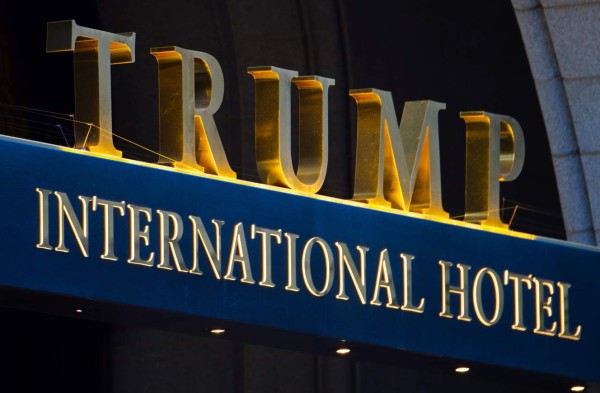 (FILES) This file photo taken on March 23, 2017 shows the sign on the Trump International Hotel in Washington,DC. The next US election is still more than 1,200 days away, but Donald Trump is already drumming up cash to pay for it -- and chose the Trump International Hotel, two steps from the White House, as a fundraising venue. On June 28, 2017, the 45th president of the United States will take part in a dinner benefiting the Republican Party and his own re-election campaign, with a seat at the table reportedly starting at $35,000. / AFP PHOTO / PAUL J. RICHARDS