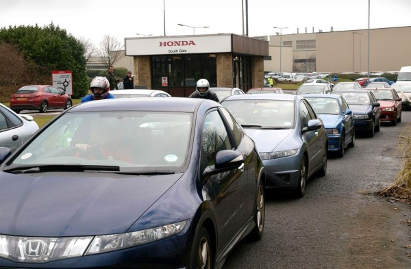 (FILES) In this file photo taken on January 30, 2009 Workers leave the Honda car factory in Swindon, southwest England. - Japanese car giant Honda is expected to announce that it will close its plant in south west England in 2022, putting 3,500 jobs at risk, according to media reports on February 18, 2019. The carmaker is due to announce the closure of its Swindon plant on Tuesday, according to Sky News, but still retain its European headquarters in nearby Bracknell. (Photo by Max NASH / AFP)