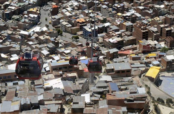 Cable-cars are seen over La Paz, considered the highest project of its kind moving at over 4,000 meters above sea level, on October 10, 2014, two days before six million Bolivians are expected to vote on the general and presidential election of October 12. Both routes over the Bolivian capital have a combined capacity to seat 18,000 users an hour. AFP PHOTO/JORGE BERNAL