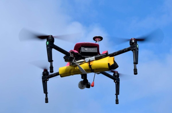 TO GO WITH AFP STORY BY JORDANE BERTRAND (FILES) This file photo taken on July 08, 2016 shows the surveillance drone 'Helper' with a life buoy, flying over the beach of Biscarrosse, on July 8, 2016, during a demonstration of a rescue operation.The 'Helper' drone, tested this summer on the beach of Biscarrosse, can take off from a rescue centre in less than thirty seconds, be placed over a swimmer in distress and drop a life buoy. It will be used by sea rescuers on beaches. / AFP PHOTO / GEORGES GOBET