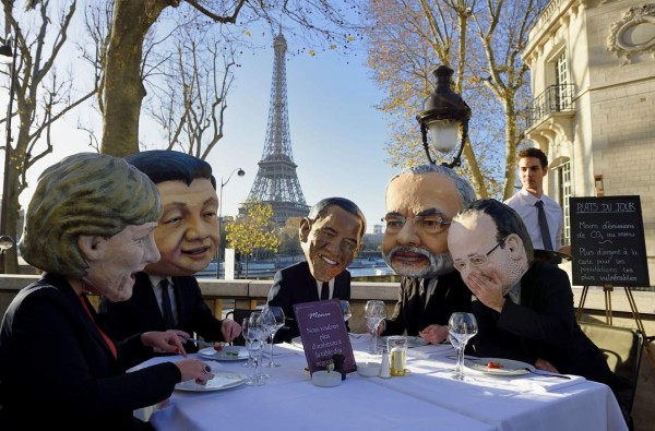 TOPSHOTSPerformers wearing effigies of world leaders (From L) German Chancellor Angela Merkel, China's President Xi Jinping, US President Barack Obama, Indian Prime Minister Narendra Modi and French President Francois Hollande gather for a breakfast organized by Oxfam NGO on November 28, 2015 in Paris, on the eve of the COP21 United Nations conference on climate change. The Paris conference will gather some 40,000 people, including 10,000 delegates from 195 countries, plus journalists, observers, scientists, exhibitors and visitors. The menu at right reads 'Today's special : Less carbon emission, More money on demand for he most vulnerable populations'. The Eiffel Tower is seen in background. AFP PHOTO / ERIC FEFERBERG