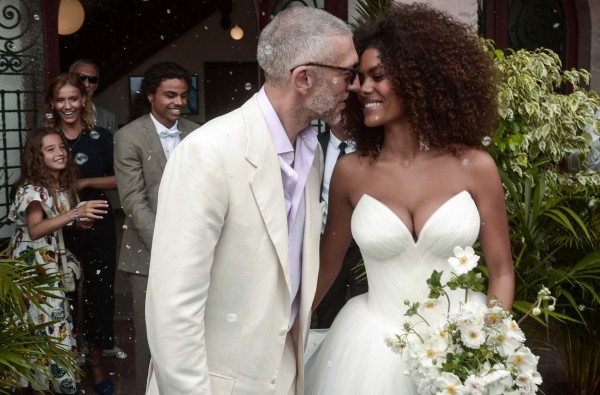 French actor Vincent Cassel (L) and French model Tina Kunakey kiss at the end of their wedding ceremony at the town hall of Bidart, southwestern France, on August 24, 2018. / AFP PHOTO / IROZ GAIZKA