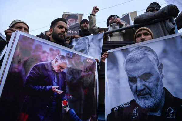 Protesters shout slogans against the United States and Israel as they hold posters with the image of top Iranian commander Qasem Soleimani, who was killed in a US airstrike in Iraq, and Iranian President Hassan Rouhani during a demonstration in the Kashmiri town of Magam on January 3, 2020. - Hundreds of people in Indian Kashmir staged 'anti-American' demonstrations in the troubled territory on January 3 within hours of US forces killing a top Iranian commander. (Photo by Tauseef MUSTAFA / AFP)