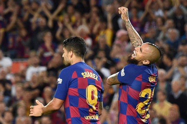 Barcelona players celebrate their second goal scored by Barcelona's Spanish defender Gerard Pique (4L) during Spanish Copa del Rey (King's Cup) semi-final second leg football match between FC Barcelona and Sevilla FC at the Camp Nou stadium in Barcelona on March 3, 2021. (Photo by Josep LAGO / AFP)