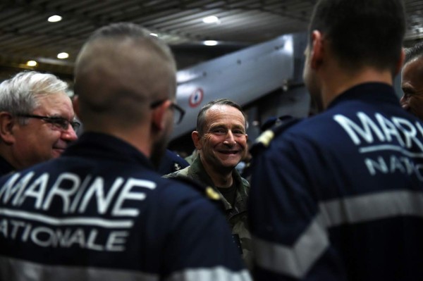 (FILES) This file photo taken on November 23, 2015 shows French Army Chief of Staff General Pierre de Villiers (C) talking to French navy soldiers in the shed of the French Charles-de-Gaulle aircraft carrier at the eastern Mediterranean sea, as part of operation Chammal in Syria and Irak against the Islamic State group. French military chief Pierre de Villiers announced to AFP in a press release on July 19, 2017 he presented his resignation to French President Emmanuel Macron 'Who accepted it'. / AFP PHOTO / ANNE-CHRISTINE POUJOULAT