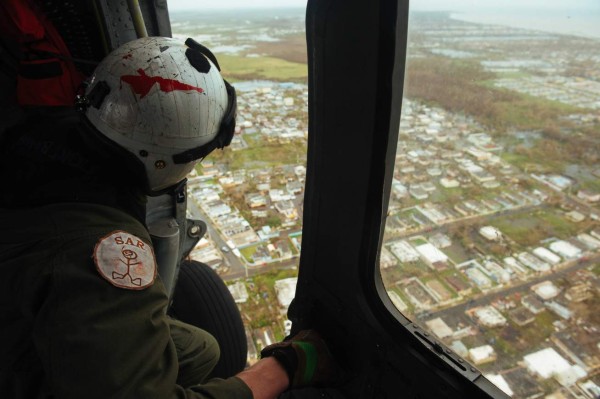 This US Navy photo obtained September 24, 2017 shows Hospital Corpsman 2nd Class Gary Haley, assigned to Helicopter Sea Combat Squadron (HSC) 7, as he conducts search and rescue operations on September 22, 2017 over San Juan, Puerto Rico following Hurricane Maria.The US Department of Defense is supporting Federal Emergency Management Agency, the lead federal agency, in helping those affected by Hurricane Maria to minimize suffering and is one component of the overall whole-of-government response effort. / AFP PHOTO / Navy Office of Information / Liam KENNEDY / RESTRICTED TO EDITORIAL USE - MANDATORY CREDIT 'AFP PHOTO / US NAVY/LIAM KENNEDY/HANDOUT' - NO MARKETING NO ADVERTISING CAMPAIGNS - DISTRIBUTED AS A SERVICE TO CLIENTS