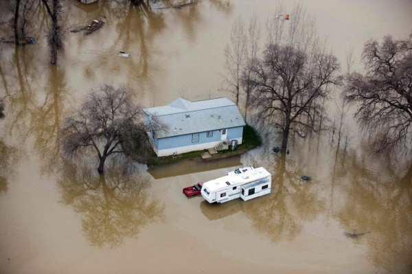 TOPSHOT - A home is seen marooned as the surrounding property is submerged in flood water in Oroville, California on February 13, 2017.Almost 200,000 people were under evacuation orders in northern California Monday after a threat of catastrophic failure at the United States' tallest dam. Officials said the threat had subsided for the moment as water levels at the Oroville Dam, 75 miles (120 kilometers) north of Sacramento, have eased. But people were still being told to stay out of the area. / AFP PHOTO / Josh Edelson