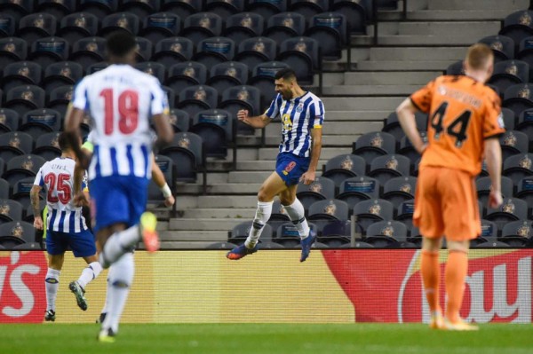 FC Porto's Iranian forward Mehdi Taremi celebrates scoring the opener during the UEFA Champions League round of 16 first leg football match between Porto and Juventus at the Dragao stadium in Porto on February 17, 2021. (Photo by MIGUEL RIOPA / AFP)