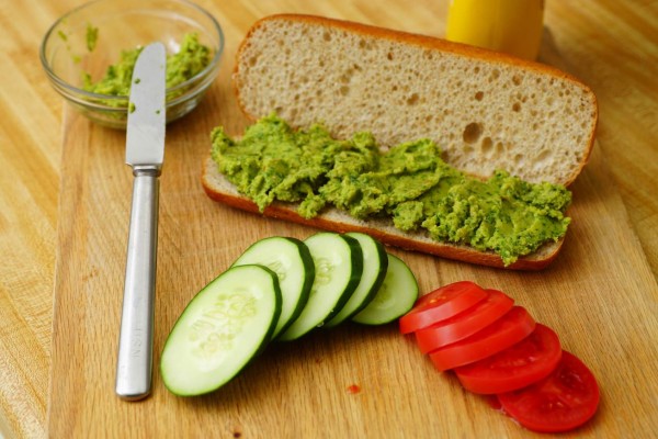 Preparation of healthy vegetarian submarine sandwich.
