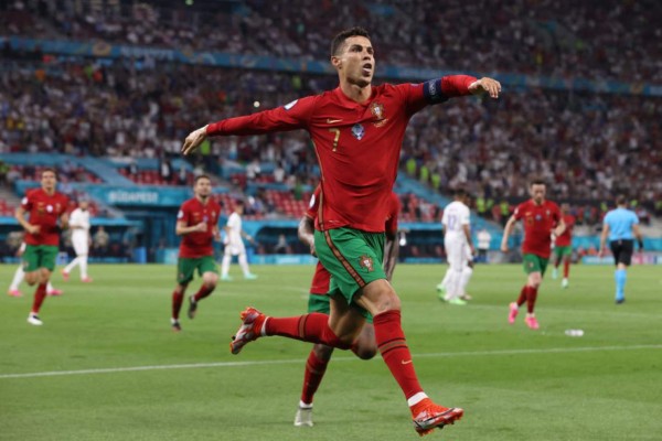 Portugal's forward Cristiano Ronaldo celebrates after scoring a second penalty kick during the UEFA EURO 2020 Group F football match between Portugal and France at Puskas Arena in Budapest on June 23, 2021. (Photo by BERNADETT SZABO / POOL / AFP)