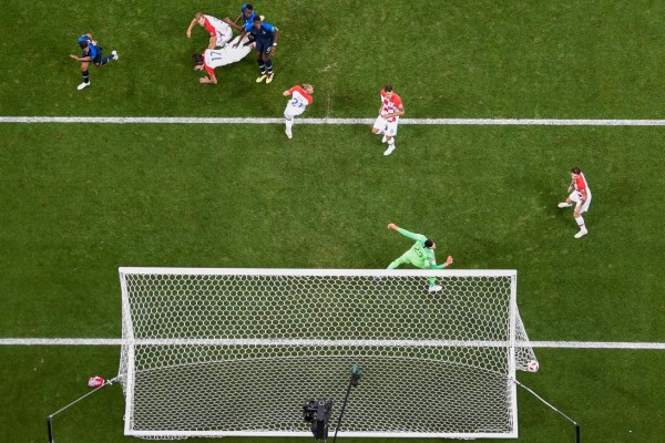 Croatia's forward Mario Mandzukic (rear C) heads the ball and scores an own goal after France's forward Antoine Griezmann (unseen) shot a free kick during the Russia 2018 World Cup final football match between France and Croatia at the Luzhniki Stadium in Moscow on July 15, 2018. / AFP PHOTO / - / RESTRICTED TO EDITORIAL USE - NO MOBILE PUSH ALERTS/DOWNLOADS