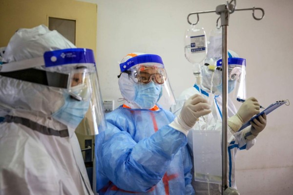 A medical staff member checks medicine used on a patient infected by the COVID-19 coronavirus at Red Cross Hospital in Wuhan in China's central Hubei province on March 10, 2020. - Chinese President Xi Jinping said on March 10 that Wuhan has turned the tide against the deadly coronavirus outbreak, as he paid his first visit to the city at the heart of the global epidemic. (Photo by STR / AFP) / China OUT