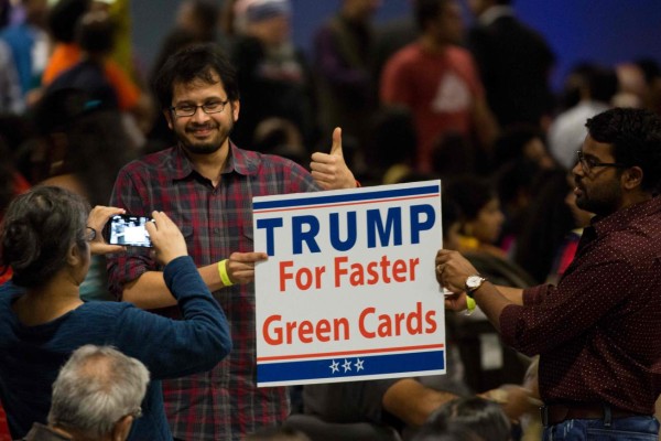 A sign suggesting Republican presidential candidate Donald Trump supports expediting work visas is seen during a Hindu political organization's anti-terror fundraiser, October 15, 2016, in Edison, NJ. / AFP PHOTO / DOMINICK REUTER