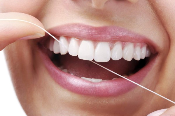 Beautiful smiling model with dental floss- XXXL Image