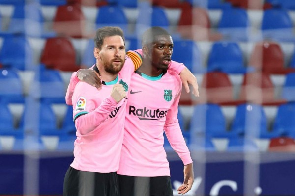 Barcelona's Argentinian forward Lionel Messi (L) celebrates with Barcelona's French forward Ousmane Dembele after scoring during the Spanish league football match Levante UD against FC Barcelona at the Ciutat de Valencia stadium in Valencia on May 11, 2021. (Photo by JOSE JORDAN / AFP)