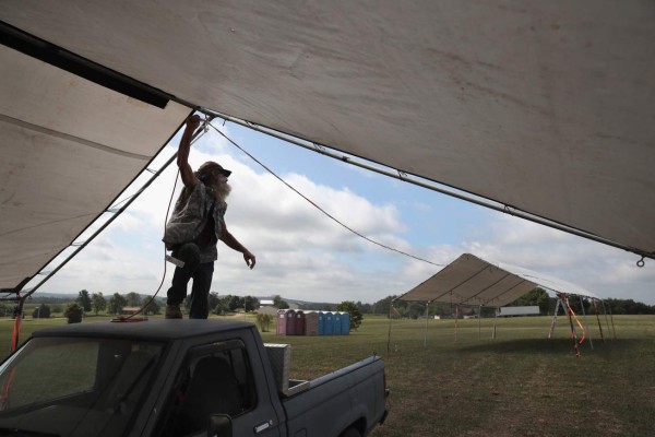 CERULEAN, KY - AUGUST 17: Kenny Mullins runs electricity to a shelter while he helps to build the site for Solquest on August 17, 2017 in Cerulean, Kentucky. Located on 75 acres in rural Western Kentucky, Solquest is a three-day religious festival located near the point of greatest totality for the August 21 eclipse. Organizers are preparing for as many as 15,000 people to attend the free festival which will run through the total eclipse on August 21. Millions of people are expected to watch as the eclipse cuts a path of totality 70 miles wide across the United States from Oregon to South Carolina. Scott Olson/Getty Images/AFP== FOR NEWSPAPERS, INTERNET, TELCOS & TELEVISION USE ONLY ==