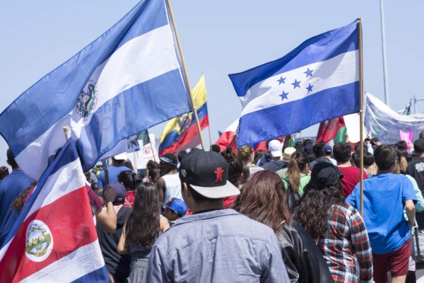 San Diego, California, USA - May 27, 2016: Protesters gather to march against Donald Trump outside a Trump rally in San Diego while carrying flags from Costa Rica, El Salvador, Honduras and other Central American nations.