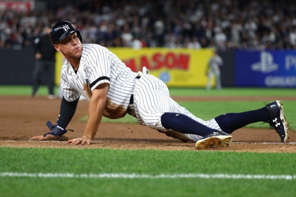 NEW YORK, NY - OCTOBER 03: Aaron Judge #99 of the New York Yankees slides safe to third base after an error by Minnesota Twins during the seventh inning in the American League Wild Card Game at Yankee Stadium on October 3, 2017 in the Bronx borough of New York City. Al Bello/Getty Images/AFP== FOR NEWSPAPERS, INTERNET, TELCOS & TELEVISION USE ONLY ==