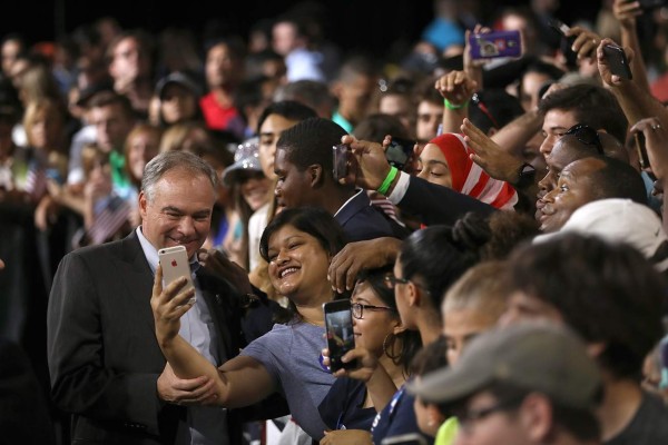 MIAMI, FL - JULY 23: Democratic vice presidential candidate U.S. Sen. Tim Kaine (D-VA) takes a selfie with a supporter during a campaign rally with democratic presidential candidate former Secretary of State Hillary Clinton at Florida International University Panther Arena on July 23, 2016 in Miami, Florida. Hillary Clinton and Tim Kaine made their first public appearance together a day after the Clinton campaign announced Senator Kaine as the Democratic vice presidential candidate. Justin Sullivan/Getty Images/AFP