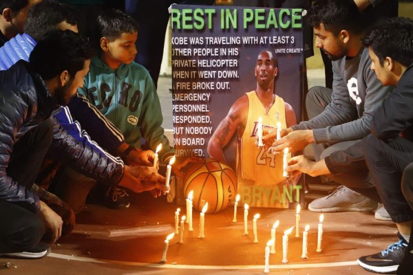 Gurgaon Basketball players light candles as they pay tribute to American professional basketball player Kobe Bryant in Gurgaon on January 27, 2020. - Basketball legend Kobe Bryant's death in a helicopter crash along with his teenage daughter sparked an outpouring of grief across the worlds of sports and entertainment on January 27. (Photo by MANOJ KUMAR / AFP)