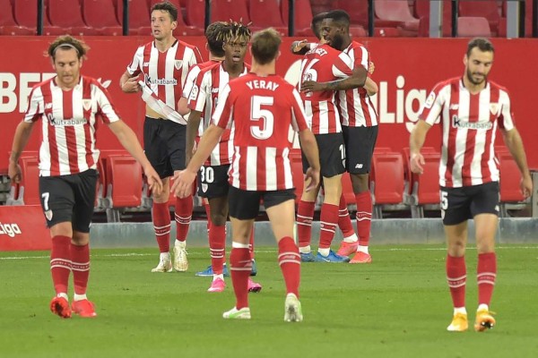 Athletic Bilbao's Spanish forward Inaki Williams (back R) celebrates with teammates after scoring a goal during the Spanish League football match between Sevilla and Athletic Bilbao at the Ramon Sanchez Pizjuan stadium in Seville on May 3, 2021. (Photo by CRISTINA QUICLER / AFP)