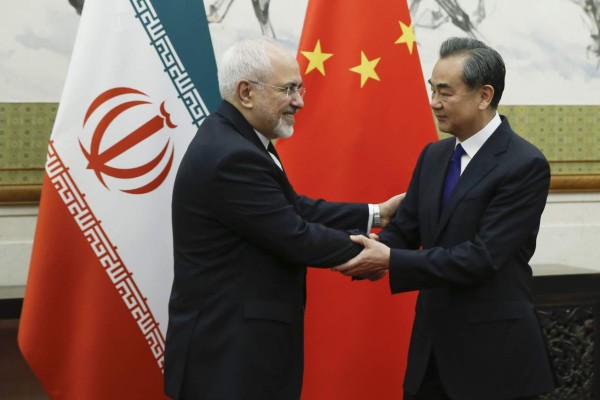 Chinese State Councillor and Foreign Minister Wang Yi (R) meets Iran's Foreign Minister Mohammad Javad Zarif at the Diaoyutai state guesthouse in Beijing on May 13, 2018.Iran's foreign minister arrived May 13 in Beijing on the first leg of a whirlwind diplomatic tour designed to try and rescue the nuclear deal left on the brink of collapse after the US pulled out. / AFP PHOTO / POOL / THOMAS PETER