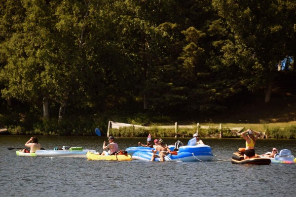 ANCHORAGE, AK - JULY 04: People float on inflatable rafts at Jewel Lake on July 4, 2019 in Anchorage, Alaska. Alaska is bracing for record warm temperatures and dry conditions in parts of the state. Lance King/Getty Images/AFP== FOR NEWSPAPERS, INTERNET, TELCOS & TELEVISION USE ONLY ==