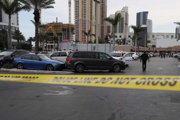 SUNNY ISLES, FLORIDA - MAY 12: Sunny Isles Beach police officers stand near a van where an individual was found shot to death after a shooting close by that reports say involved rapper NBA Youngboy on May 12, 2019 in Sunny Isles, Florida. Police continue to investigate both of the scenes near the Trump International Beach Resort. Joe Raedle/Getty Images/AFP== FOR NEWSPAPERS, INTERNET, TELCOS & TELEVISION USE ONLY ==