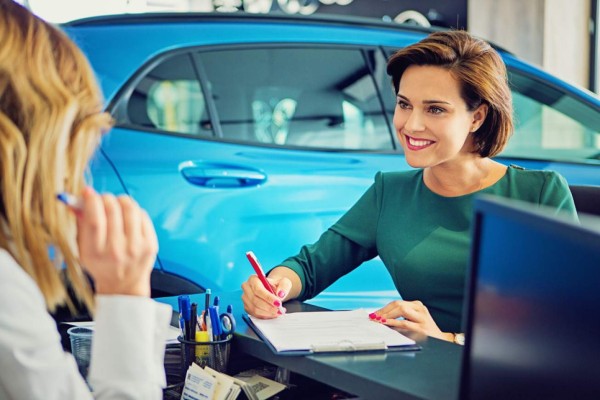 Car dealer sales car to the customer and discuss the deal